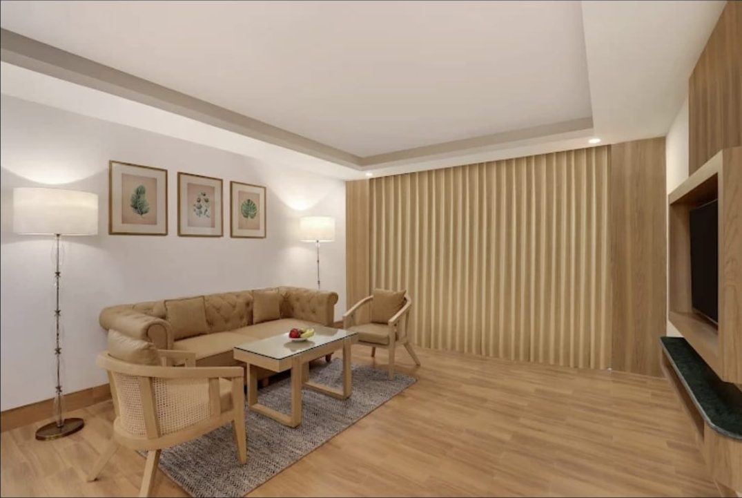 Compact sofa and armchairs in a suite living area, the kind of footprint a sofa bed has to fit