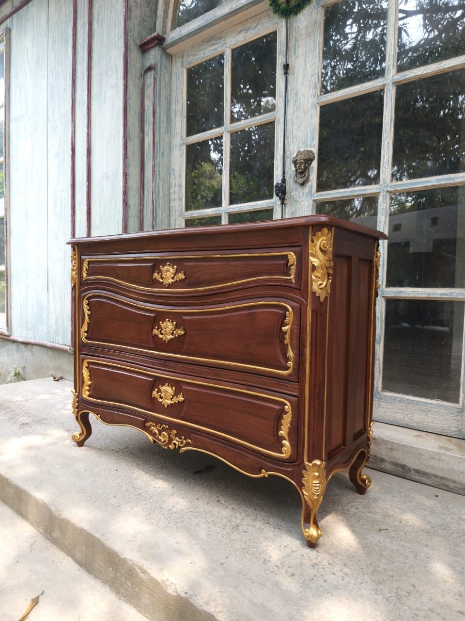 French Louis XV style commode with serpentine drawer fronts, gilt mounts and scrolled feet