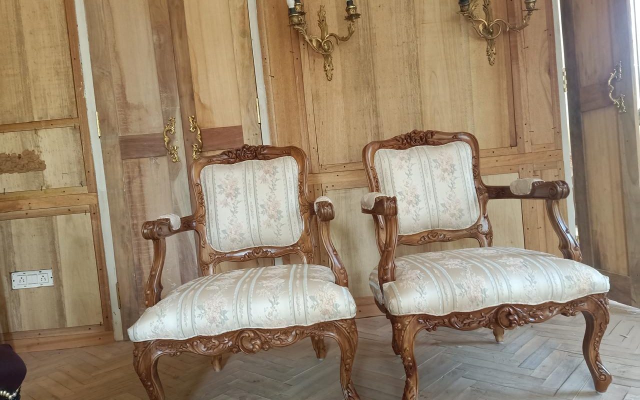 Pair of carved bergere armchairs made to order in Dubai