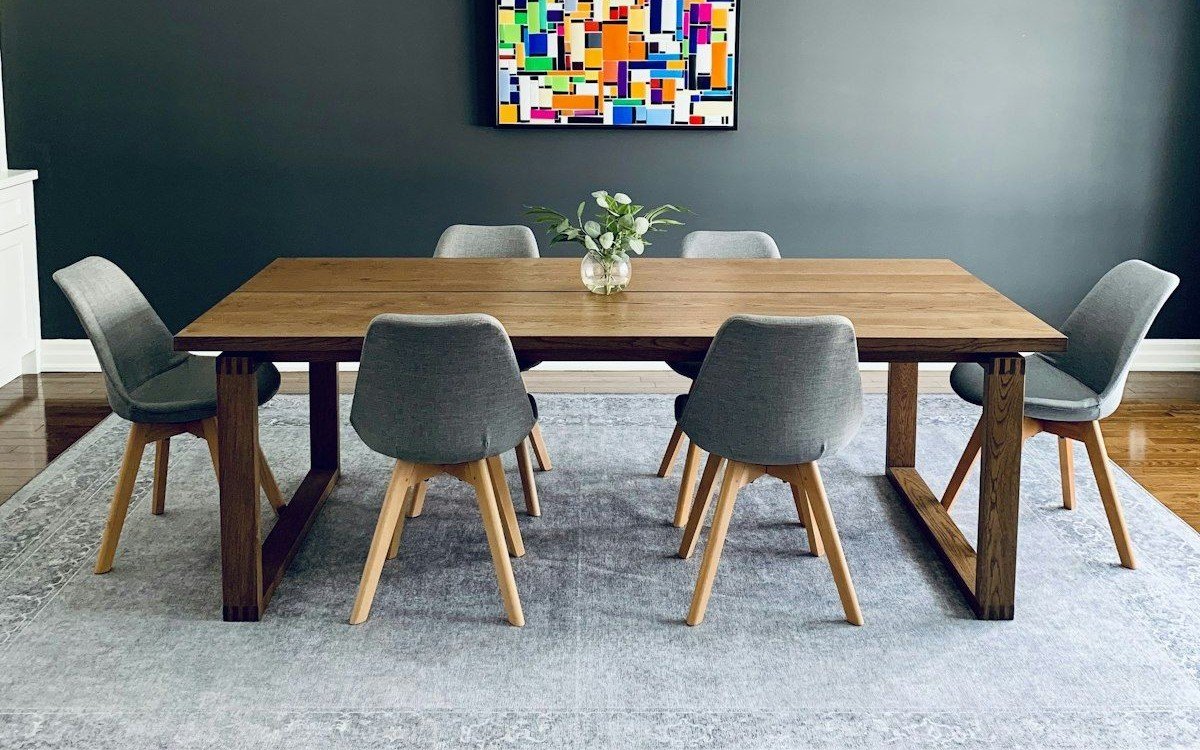 Solid wood dining table on sled-frame legs