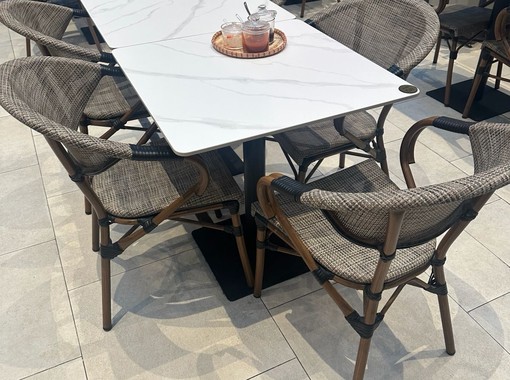 ELEV&Eacute; outdoor dining table with woven rattan chairs