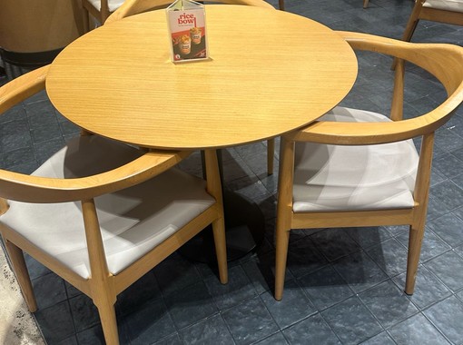 ELEV&Eacute; round wooden dining table with minimalist chairs