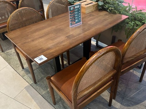 ELEV&Eacute; wooden dining table with cane-back chairs