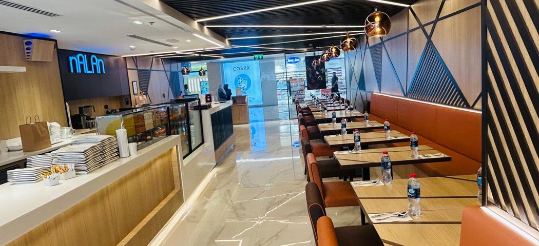 ELEV&Eacute; contemporary dining space with geometric wall panels and pendant lights