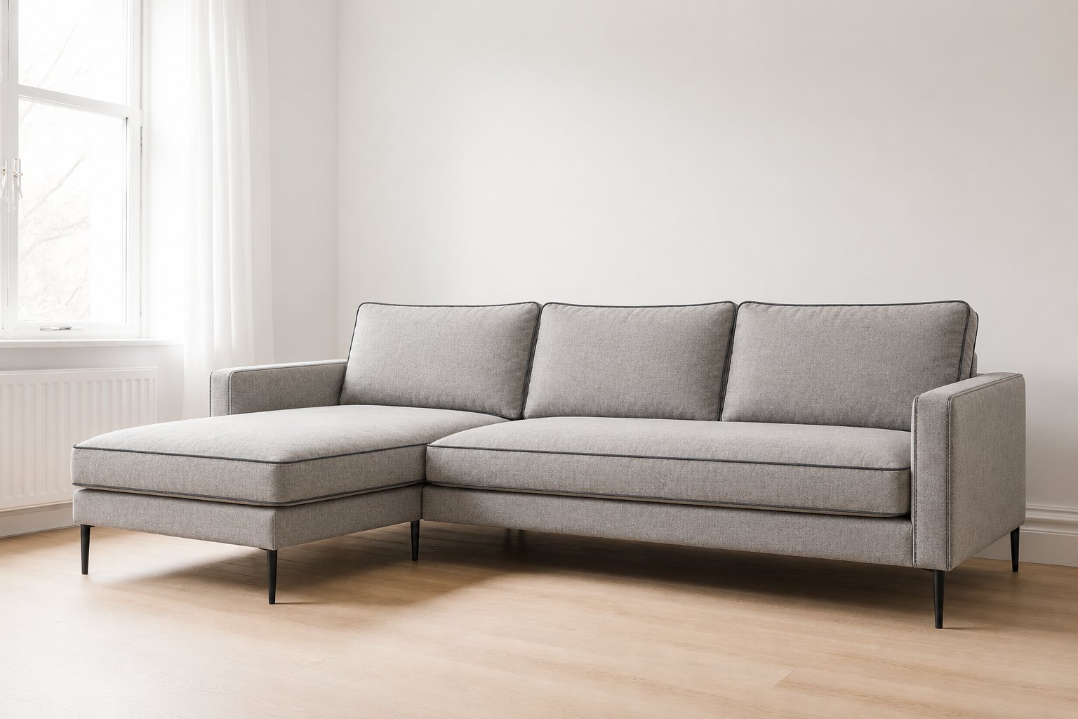 ELEV&Eacute; Tailored L-shaped sofa in light grey with loose back cushions, charcoal contrast piping and matt black legs, made to order in Dubai